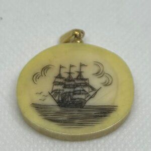 Scrimshaw oval pendant with engraved sailing ship. Folk art style/ intricate.